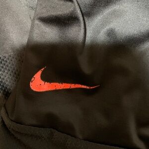 Nike Black Athletic Shorts with Red Swoosh Accent